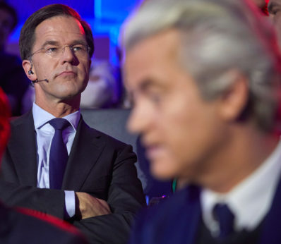 Dutch Prime Minister Mark Rutte, left, and PVV party leader Geert Wilders, right, wait to take their turn in the closing debate at parliament in The Hague, Netherlands, Tuesday, March 14. | Phil Nijhuis / AP