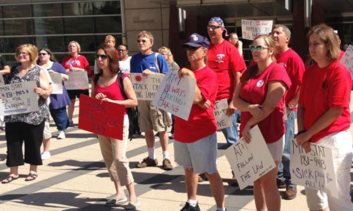 Minnesota, workers want AT&T to comply with state paid leave law