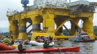 Kayakers paddling in Seattle Port chant, “Shell No”