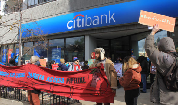 Chicago No DAPL protestors stand in front of local Citibank branch encouraging people to divest their funds. | Michelle Zacarias/PW