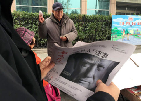 A Chinese man holds up a newspaper on Nov. 10, 2016 with a front page photo of U.S. President-elect Donald Trump with the headline: “Outsider counter attack.” | Ng Han Guan / AP