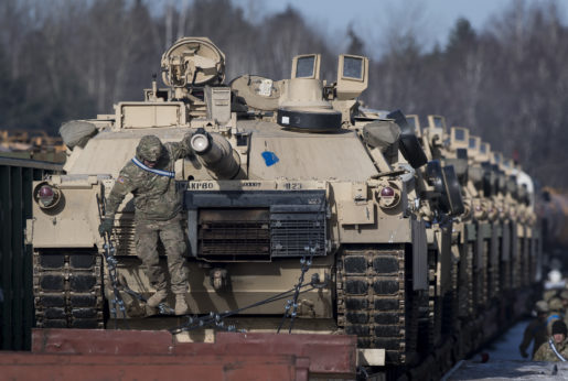 Tanks from the U.S. Army's 4th Infantry Division on rail cars as they arrive at the Gaiziunai Railway Station some 70 miles west of the Lithuanian capital, Vilnius, on Feb. 10, 2017. As part of the NATO military alliance, U.S. military forces have now pushed all the way into former Soviet territory and right up to the Russian border. | Mindaugas Kulbis / AP