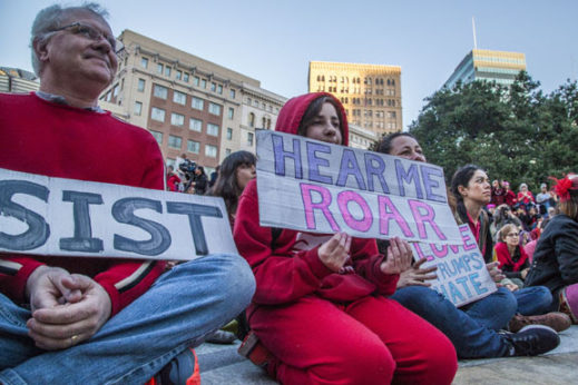 OAKLAND, CA - 8MARCH17 - A mother, father and their daughter celebrate International Women's Day in front of Oakland City Hall.Copyright David Bacon