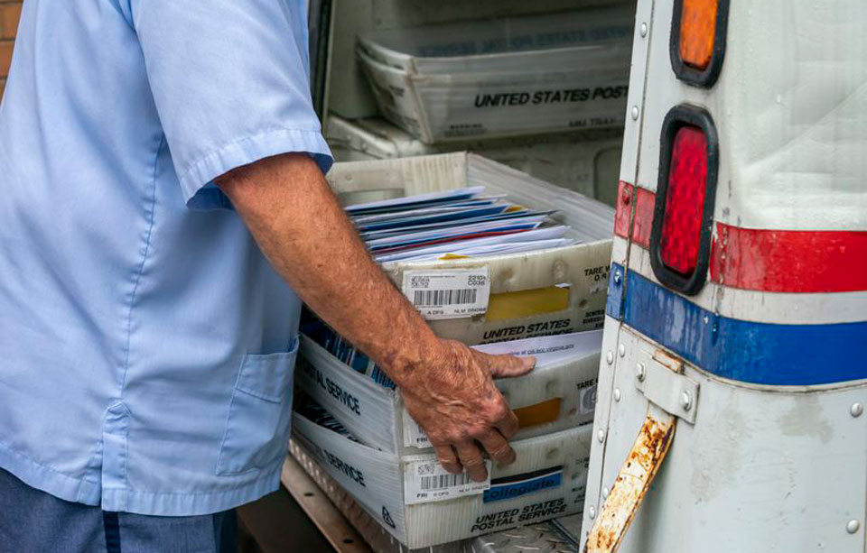 Postmaster General, a Trump crony, admits slowing the mail