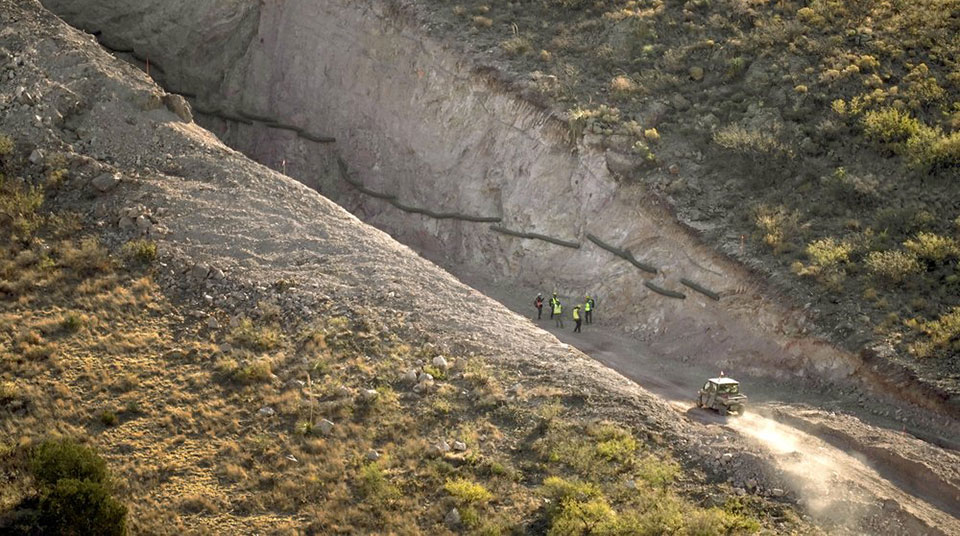 Blown-up mountains and toppled cactus, damage from border wall