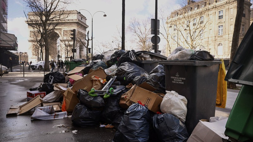 Garbage piles up in Paris streets as Macron prepares to trash workers’ retirement