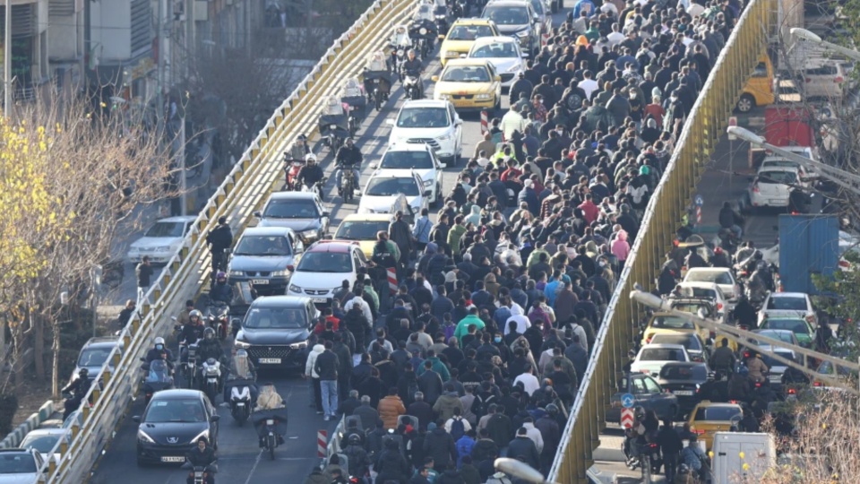 What triggered the latest mass protests in Iran?